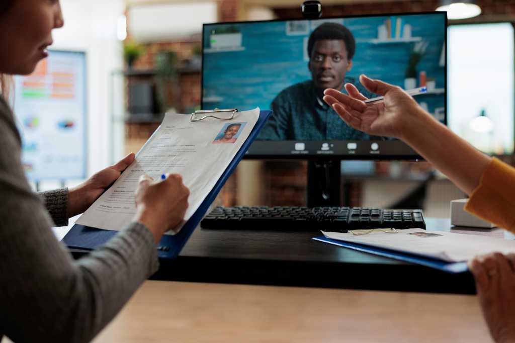 Manager women working at hiring application discussing curriculum vitae with remote recruiter during online videocall meeting conference in startup office. Teleconference call on computer screen