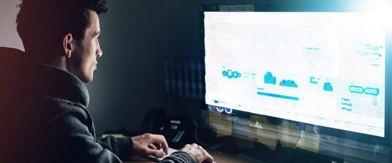 dark office and man at computer