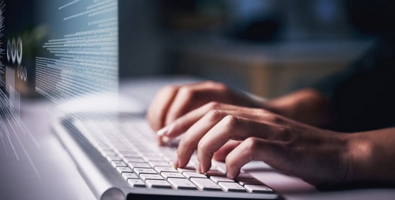 hands typing on keyboard