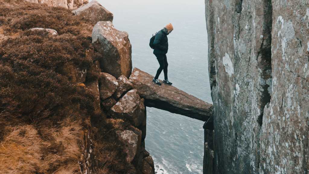 risk walking on a narrow boulder