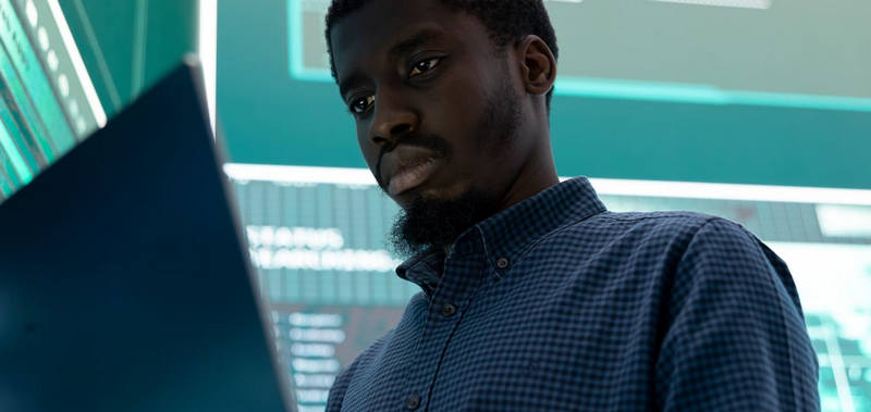 a person with a laptop in a data center room